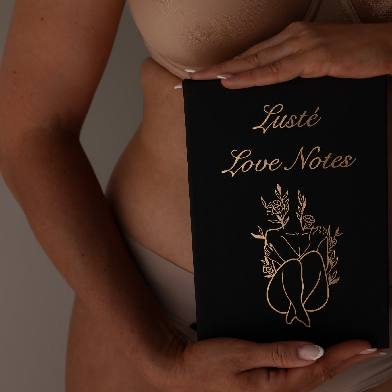Bare woman holding Lustè journal