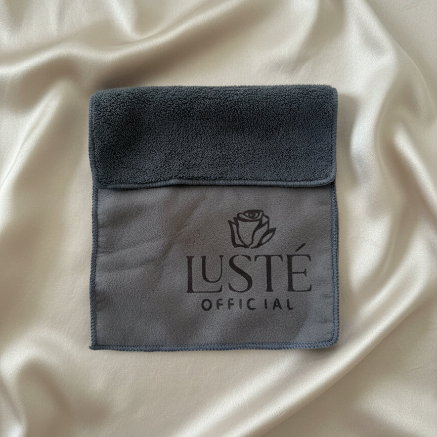 Luste Official branded cleaning cloth on gold satin